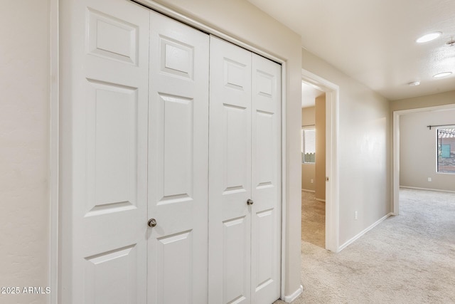 corridor with light colored carpet