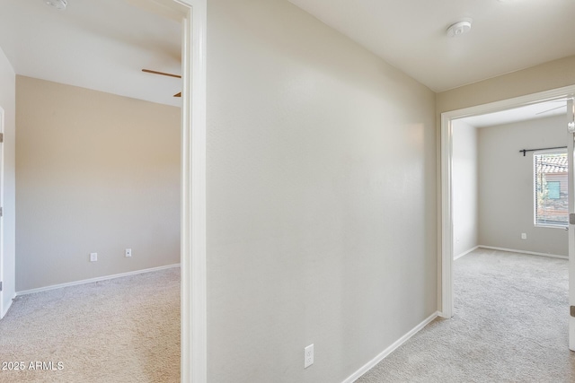 hall featuring light carpet and lofted ceiling