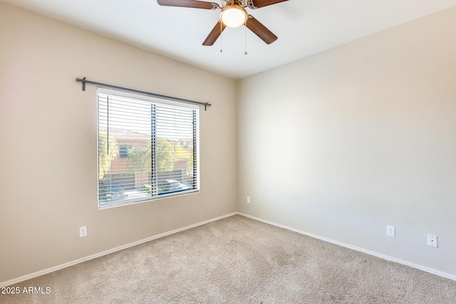 carpeted empty room featuring ceiling fan