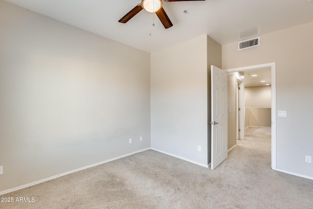 empty room featuring light carpet and ceiling fan