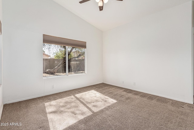 carpeted spare room with vaulted ceiling and ceiling fan