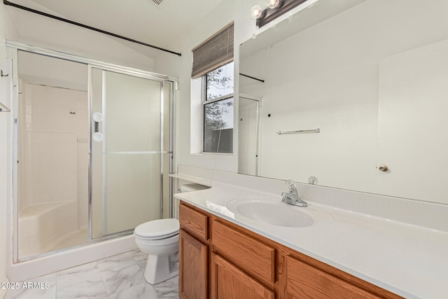 bathroom featuring vanity, a shower with door, and toilet