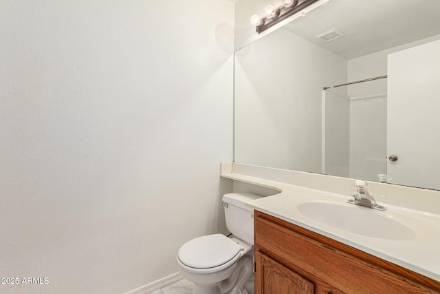 bathroom featuring vanity, a shower, and toilet