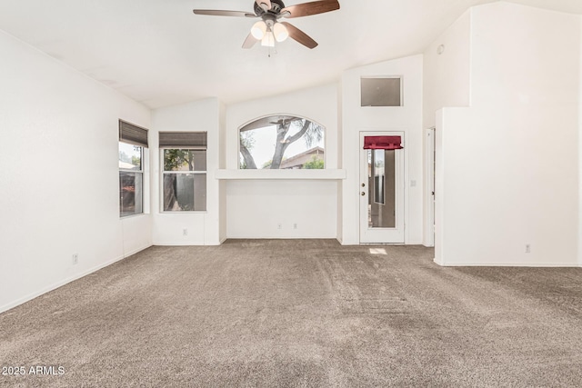 unfurnished living room featuring vaulted ceiling, ceiling fan, and carpet flooring