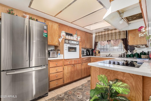 kitchen with appliances with stainless steel finishes and light tile patterned floors