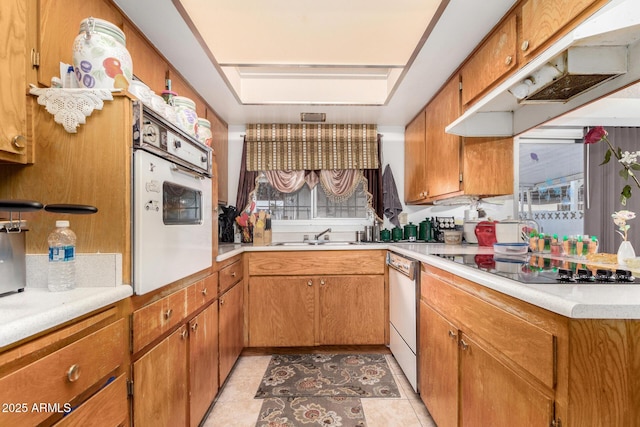 kitchen with sink, dishwasher, light tile patterned floors, white oven, and black electric stovetop