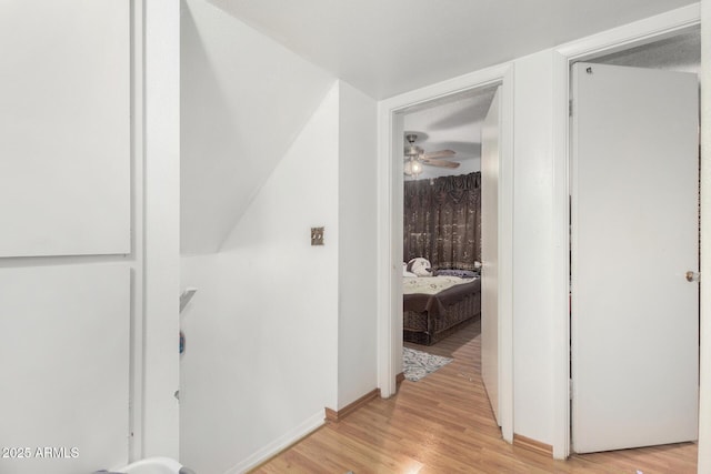 corridor with light wood-type flooring