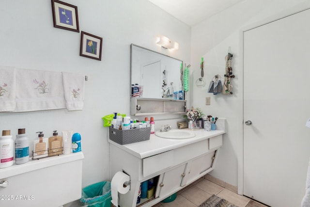 bathroom featuring tile patterned flooring, vanity, and toilet