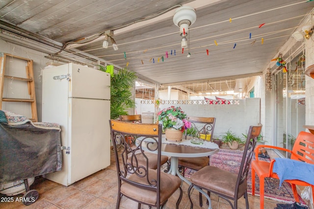 dining room with light tile patterned flooring and plenty of natural light