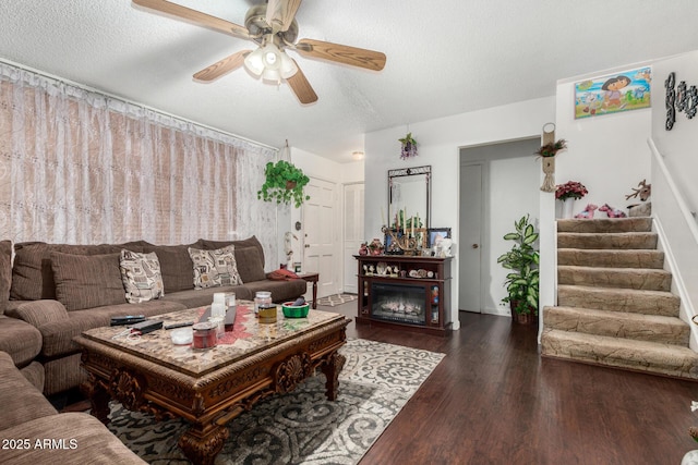 living room featuring a textured ceiling, ceiling fan, and dark hardwood / wood-style floors