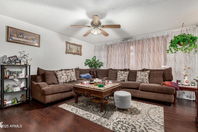 living room featuring a textured ceiling, dark wood-type flooring, and ceiling fan