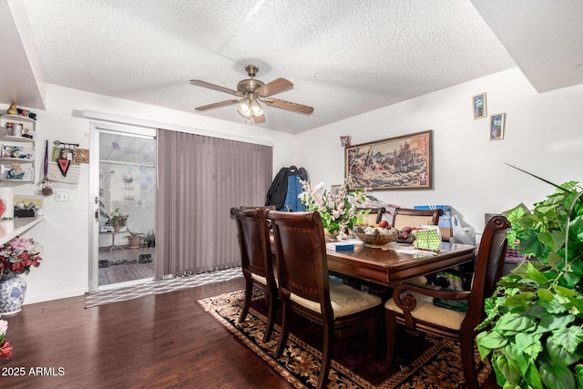 dining area with ceiling fan, dark hardwood / wood-style flooring, and a textured ceiling