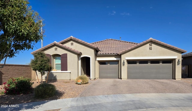 mediterranean / spanish house featuring a garage