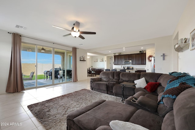 tiled living room with ceiling fan