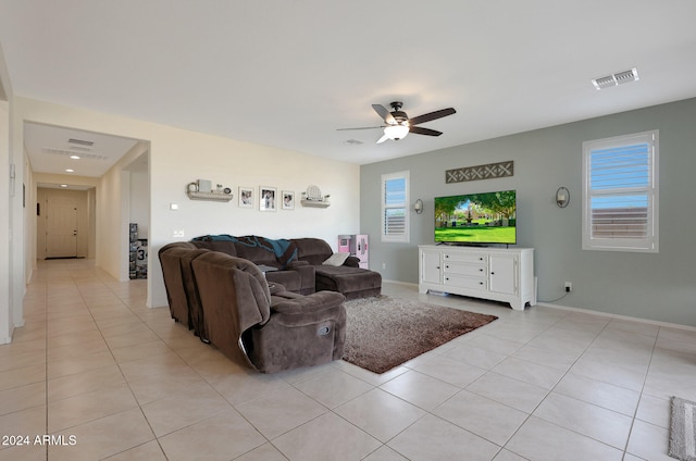 living room featuring ceiling fan and light tile patterned flooring