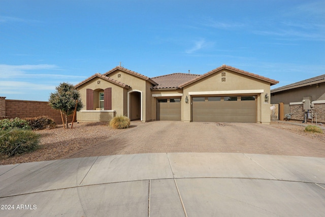 mediterranean / spanish-style home featuring a garage