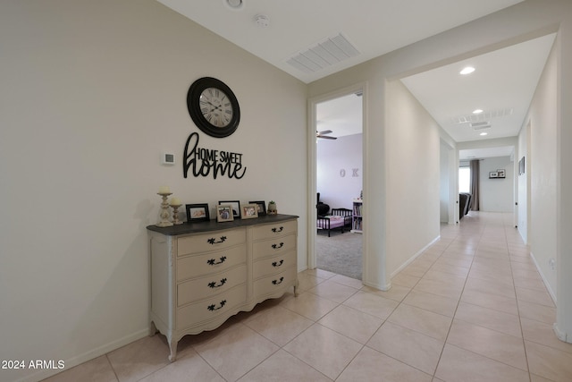 hall featuring light tile patterned floors