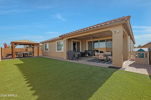 back of house featuring a gazebo, ceiling fan, a patio area, and a lawn