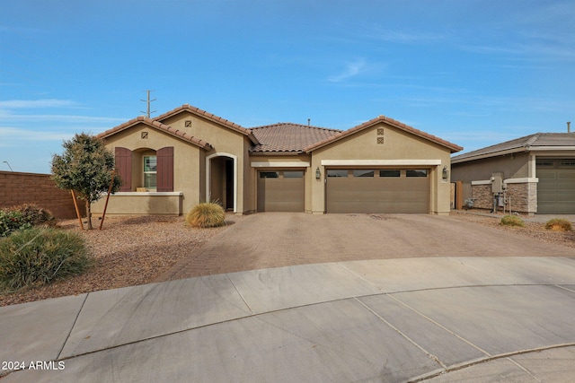 mediterranean / spanish-style home with a garage