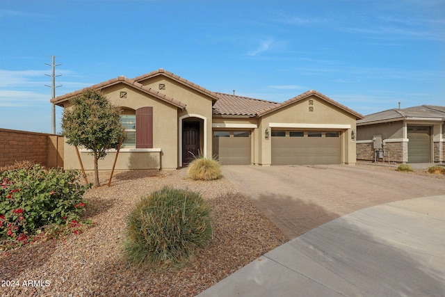 mediterranean / spanish-style house with a garage