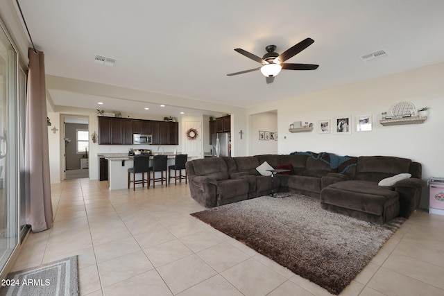 living room featuring ceiling fan and light tile patterned flooring