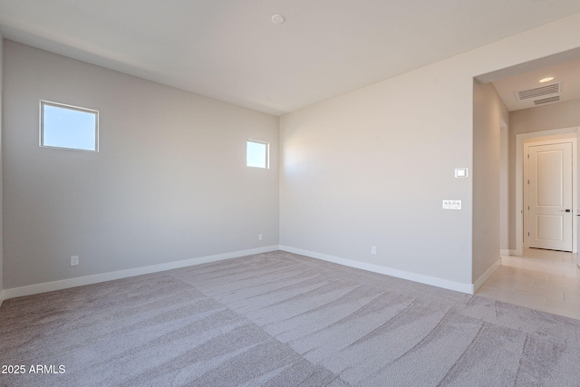 empty room featuring light carpet