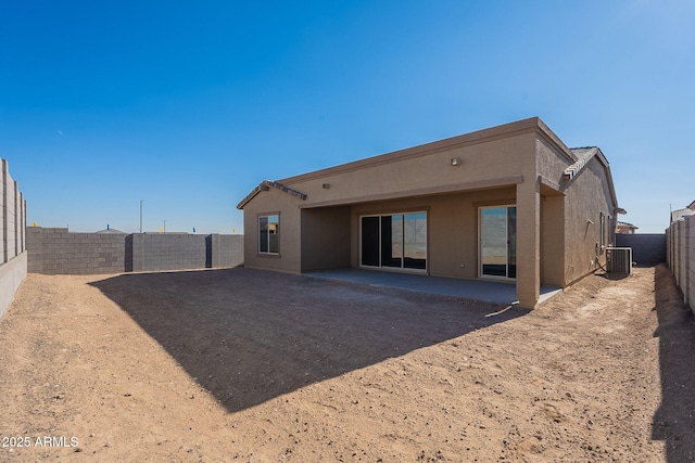 rear view of house with a patio area and central AC