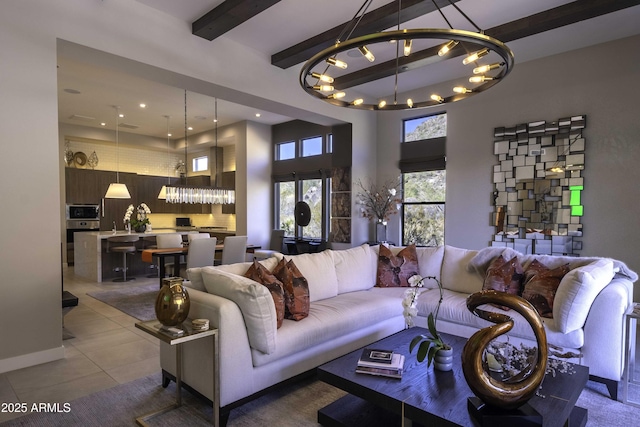 living room featuring tile patterned flooring, a notable chandelier, and beam ceiling