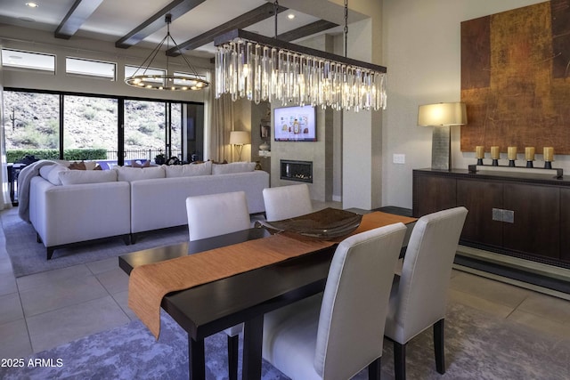 tiled dining area with a fireplace and beamed ceiling