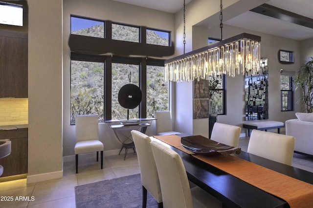 dining space with a notable chandelier and tile patterned floors