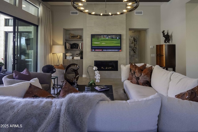 living room featuring built in shelves and a tile fireplace