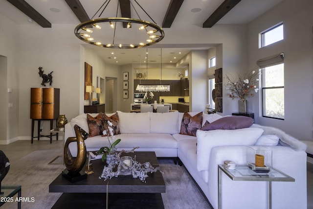 living room with beam ceiling and a chandelier