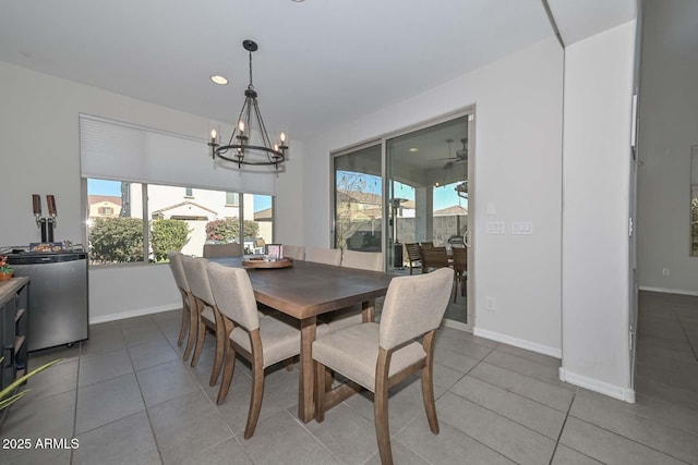 dining area featuring tile patterned floors and a notable chandelier