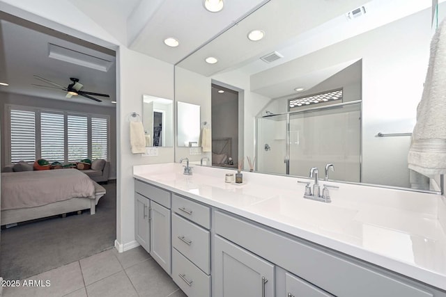 bathroom with tile patterned flooring, vanity, ceiling fan, and walk in shower