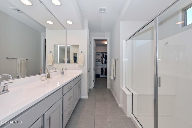 bathroom featuring an enclosed shower, vanity, and tile patterned floors