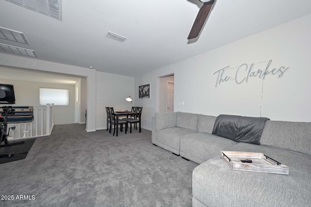 living room with ceiling fan and carpet