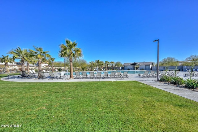 view of home's community featuring a pool and a lawn