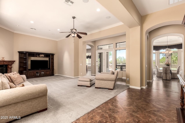 living area with arched walkways, baseboards, a chandelier, a ceiling fan, and recessed lighting