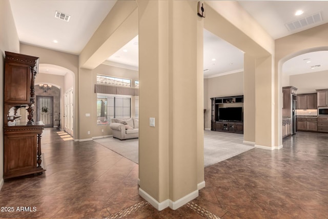 hall with arched walkways and baseboards