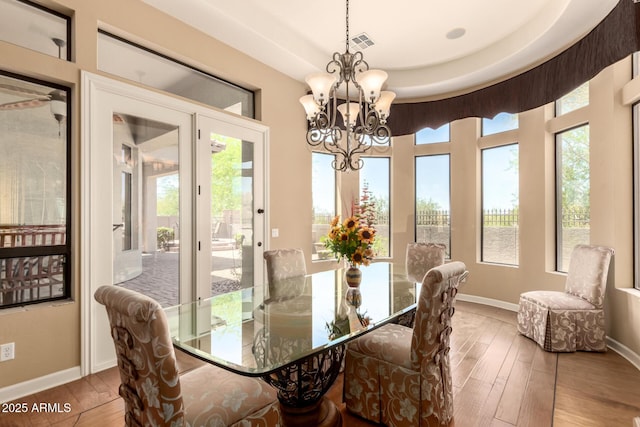 dining room with light wood finished floors, baseboards, and plenty of natural light