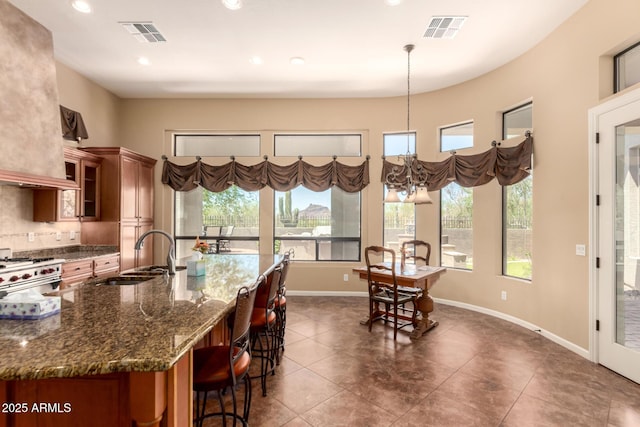 kitchen featuring a sink, brown cabinetry, healthy amount of natural light, and recessed lighting