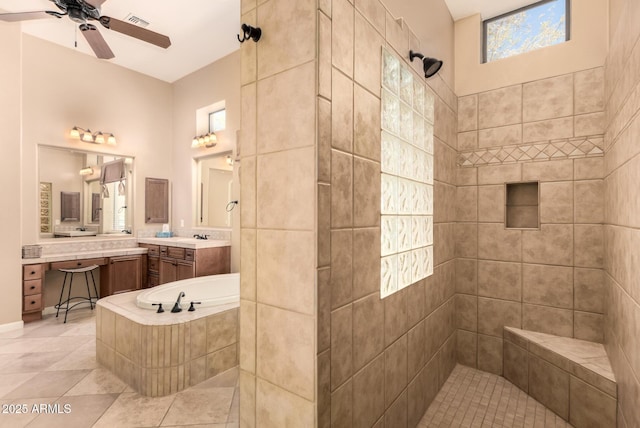 full bath featuring a tile shower, a ceiling fan, tile patterned flooring, and vanity