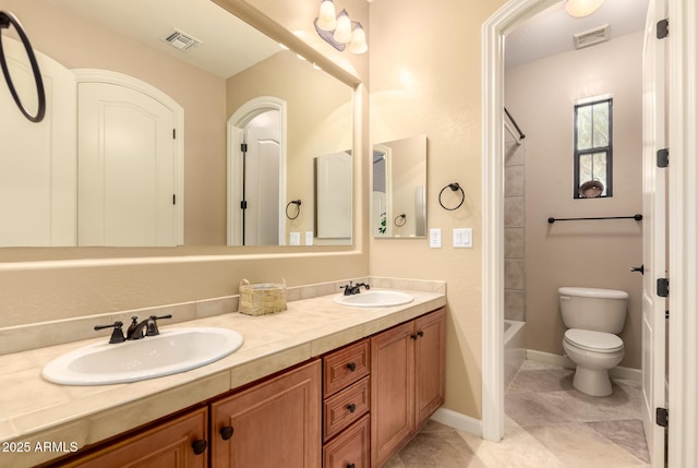 full bathroom featuring toilet, double vanity, tile patterned floors, and baseboards