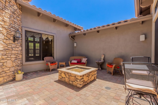 view of patio with a fire pit