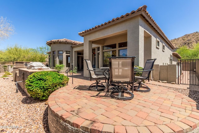 7134 E Sandia St, Mesa, AZ 85207 - view of patio / terrace featuring a gate, a mountain view, outdoor dining area, and fence