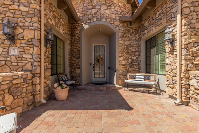 doorway to property featuring stone siding