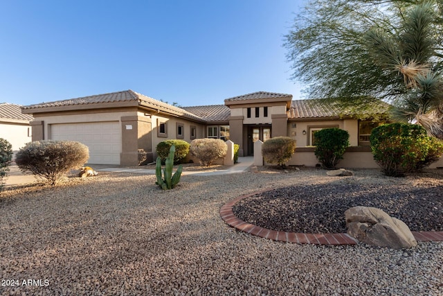 mediterranean / spanish home featuring a garage