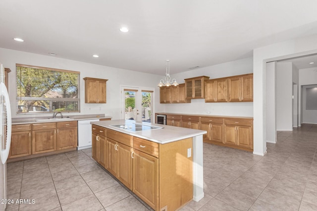 kitchen with decorative light fixtures, dishwasher, sink, a center island, and black electric cooktop