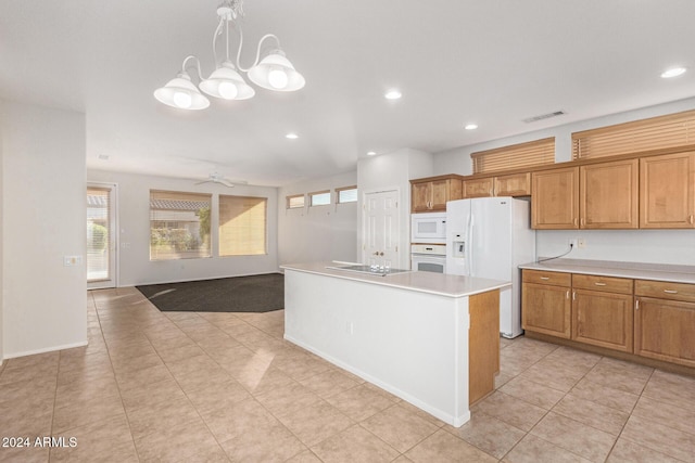 kitchen with pendant lighting, light tile patterned floors, white appliances, ceiling fan, and a kitchen island