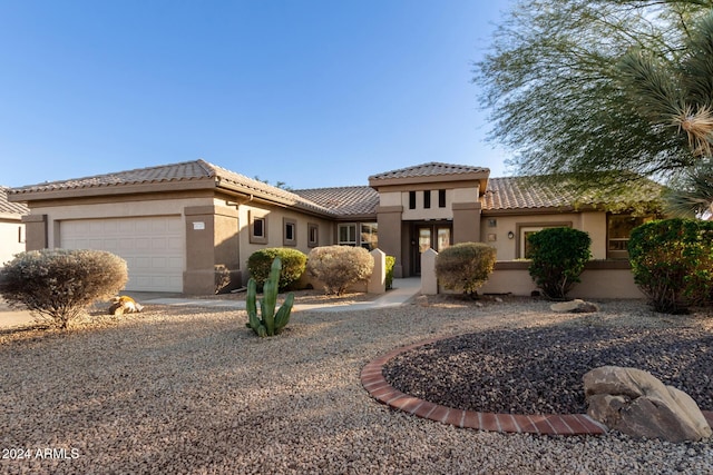 mediterranean / spanish-style home with a garage